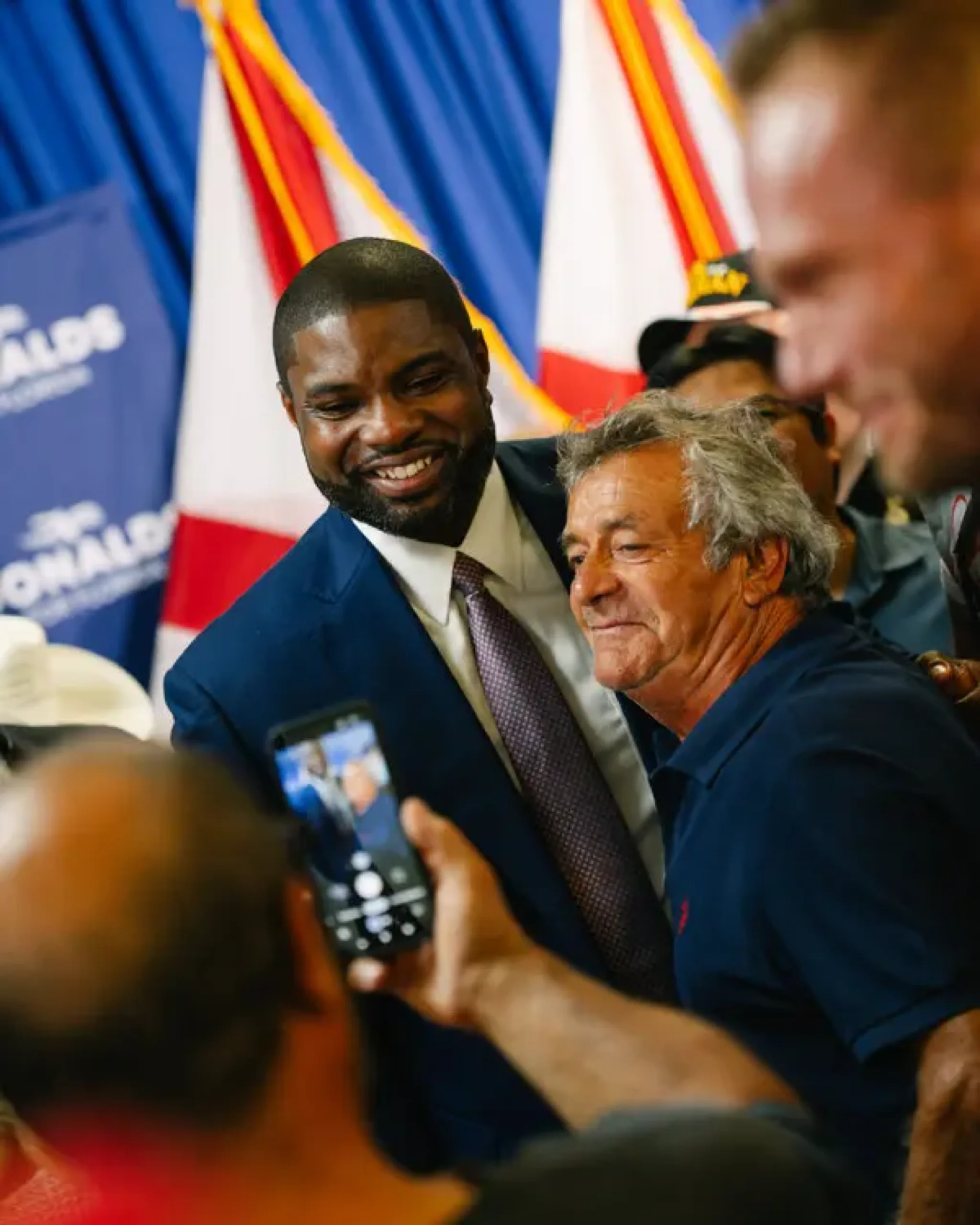 Byron Donalds taking a selfie with a supporter at a campaign event